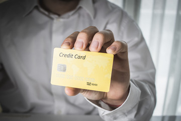 Fototapeta na wymiar male hand with credit card on white background