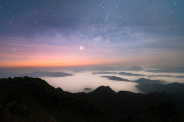 The scenery of Phu Chi Dao that plenty of sea of mist and the Milky Way above in Chiang Rai province, Thailand.