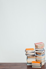 a lot of stacks of educational books for college exams in the library on a white background