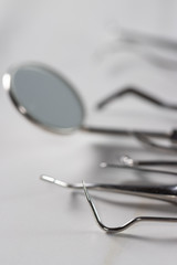 Dentist tools: mirror, dental probe and tweezers