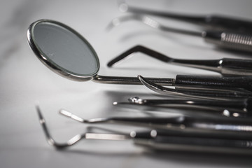 Dentist tools: mirror, dental probe and tweezers