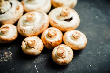 Freshly harvested mushrooms on the rustic wooden background. Selective focus. Shallow depth of...