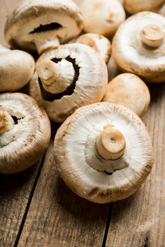 Freshly harvested mushrooms on the rustic wooden background. Selective focus. Shallow depth of field.