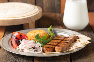 Turkish Adana Kebap With Rice Pilaf And Vegetables Served On A Plate