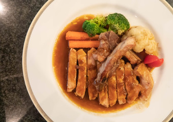 Grilled chicken with soy sauce on white plate