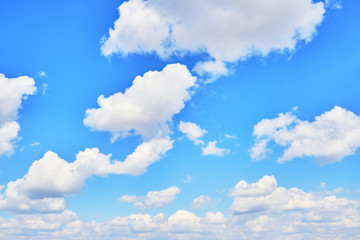 Background, Cumulus clouds in a bright blue sky.