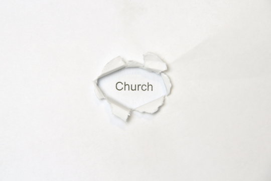 Word church on white isolated background, the inscription through the wound hole in the paper. Stock photo for web and print with empty space for text and design.