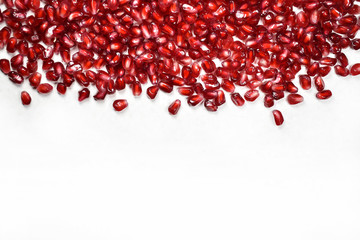 pomegranate seeds on a white background
