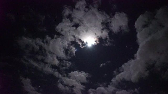 vid&eacute;o en temps r&eacute;el de plusieurs satellites align&eacute;s et se d&eacute;pla&ccedil;ant &agrave; &eacute;gale distance en passant devant la lune qui est partiellement derri&egrave;re les nuages