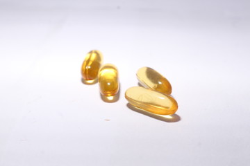 omega 3 capsule fish oil with white background in golden color 