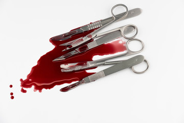 Surgical instrument tools with blood, scalpel with blade, forceps tweezers, scissors for surgeon in surgery