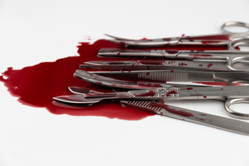 Surgical instrument tools with blood, scalpel with blade, forceps tweezers, scissors for surgeon in surgery