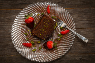 slice of chocolate cake and decoration on a glass plate