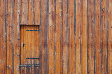 Wooden wall from planks with a door on the left side, 