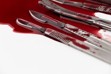 Surgical instrument tools with blood, scalpel with blade, forceps tweezers, scissors for surgeon in surgery