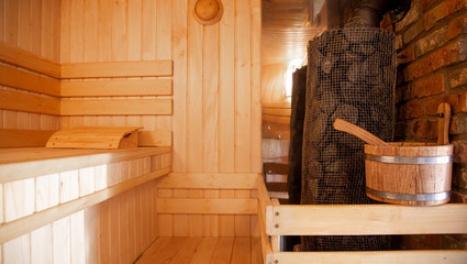 Fototapeta na wymiar Interior of a wooden Russian sauna with traditional items for use.