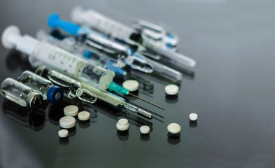 Thermometer, pills, injection vaccine ampoules, syringe for vaccination on glass background, Coronavirus, MERS-CoV,Wuhan coronavirus 2019-nCoV,concept of Corona virus quarantine,Covid-19.