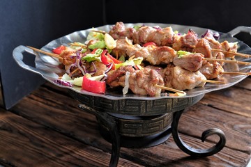 shish kebab on skewers on the iron pan