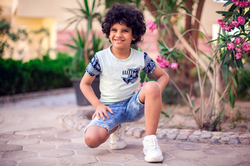 A portrait of smiling kid boy outdoor. Children and emotions concept