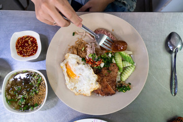 Vietnamese broken rice with grilled pork chop, fried egg and meatloaf