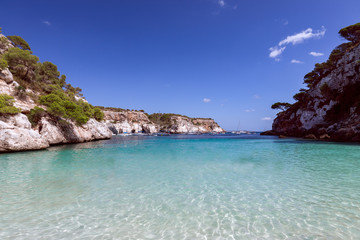 Fototapeta premium View of the beautiful little beach Cala Macarelleta with clear emerald water of the island Menorca, Balearic islands, Spain