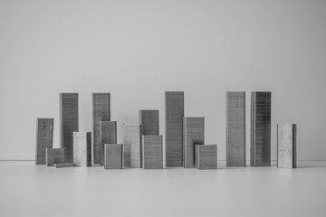 A fake cityscape styled from staplers designed to look like skyscrapers and city block towers against a white background
