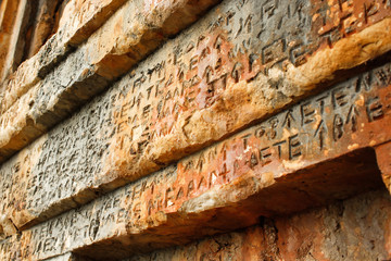 Old broken ruins of excavation of architectural stone walls