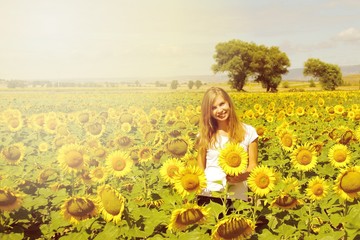 Beauty joyful teenage girl with sunflower enjoying nature and laughing on summer sunflower field. Sunflare, sunbeams, glow sun. Backlit