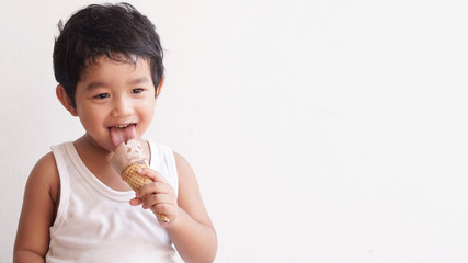 Little boy eating ice cream at home kid has dirty mouth with chocolate summer time concept. 