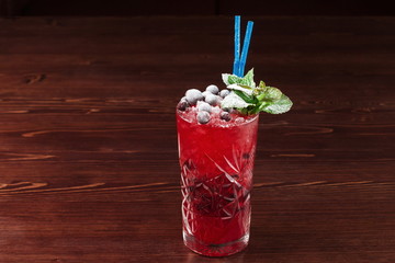 Pink and red Fresh colorful exotic alcoholic cocktail with ice in the bar.