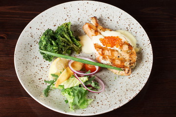 Fresh cooked delicious salmon steak with spices and herbs baked on a grill.