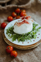 Homemade Organic Mozzarella Cheese with Tomato. Prosciutto, mozzarella and arugula. Buffalo mozzarella