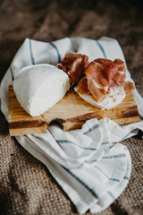 Prosciutto and mozzarella on wooden table. Top view