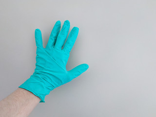 DiDisposable blue medical gloves on hands