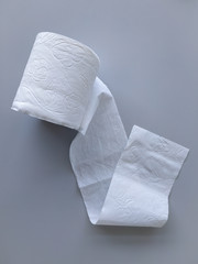 White toilet paper on a gray background