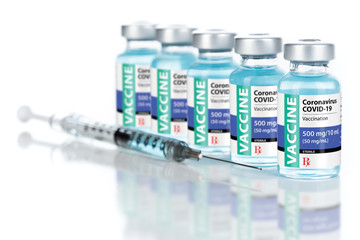 Coronavirus COVID-19 Vaccine Vials and Syringe On Reflective Surface