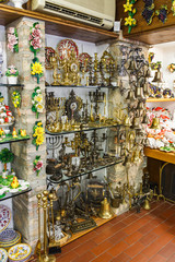 The showcase of a souvenir shop selling decorative items made of copper and other metals in the Sirmione town in Lombardy, northern Italy