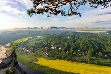 looking down to the village of Rathen in saxon switzerland in Germany while the sun is rising