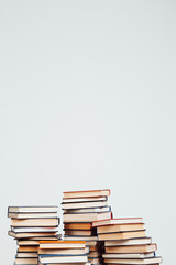 a lot of stacks of educational books for college exams in the library on a white background