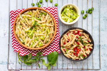 Vegan lunch food. Italian vegetables pasta or macaroni dish with greens. 