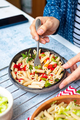Colorful Italian pasta or macaroni with red bell pepper vegetables and mint. Vegan food