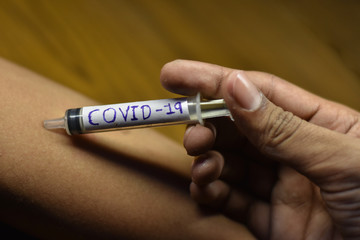 Obraz premium corona antivirus vaccines inject in boy hand with blur background 