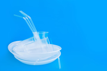 Social environmental issue. Plastic pollution of the planet. White plastic on a blue background. Ecological catastrophy. Sorting and processing of a stick. Plastic waste in the environment.Eco-problem