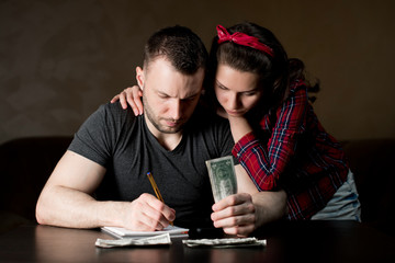 A man and a woman are sad that little money is left and difficult financial times are coming