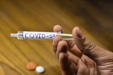 corona antivirus vaccines in a boy hand with blur background, stay home stay safe  