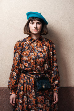 Portrait Of Brunette Woman Wearing Beret And Vintage Floral Dress
