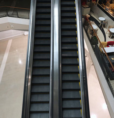 An empty, non-working escalator in the closed department store due to state's policy in response to COVID-19 outbreak