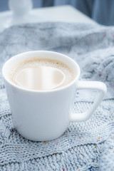 Cup with coffee milk for breakfast. Chicory with coconut milk on a gray background. Black tea with milk in a white cup.