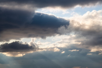 Dark clouds in the blue sky before a thunderstorm. Abstract contrasting background.