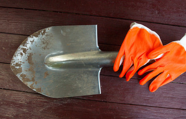 Metal spade and protective gloves